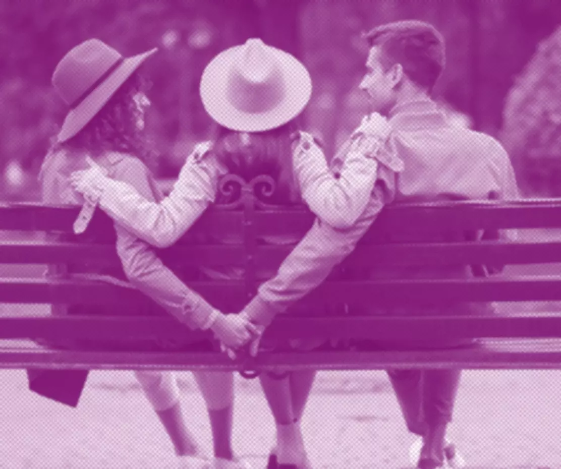 throuple sitting on a bench 